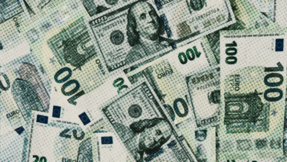 Euro and US dollar banknotes overlapping, green hundred-euro notes outnumbering the dollar bills
