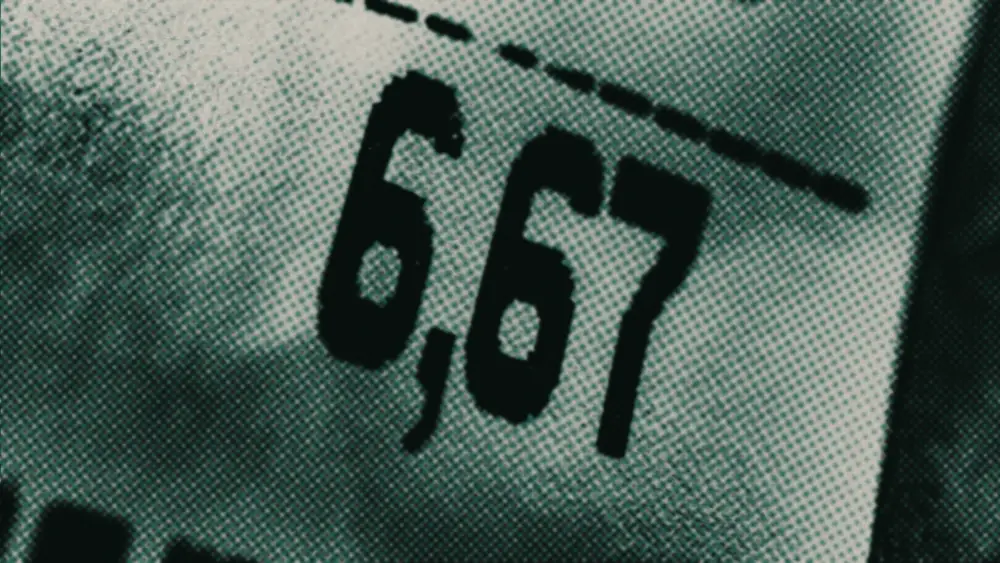 Close-up of a price tag showing 6,67 in sharp focus beneath a dashed perforation line