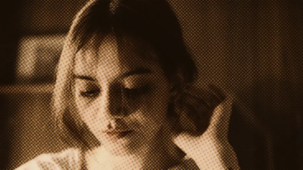 Young woman alone in warm low evening light, eyes lowered, calm and quietly reflective